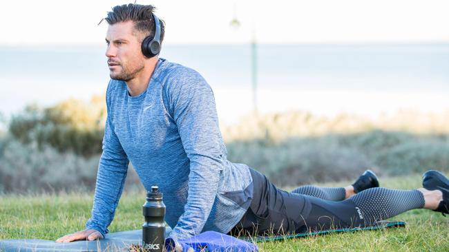 Sam Wood hits the yoga mat outdoors.