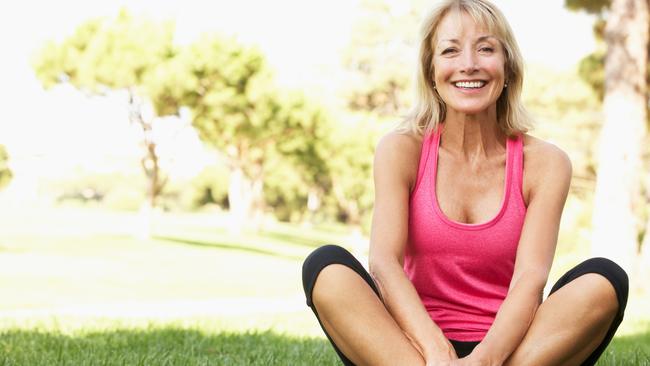 Senior Woman Resting After Exercising In Park Smiling To Camera, active and happy retiree generic