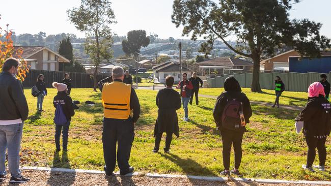 Public health team members speak just before they can door knocking during a COVID-19 testing blitz. Picture: Getty