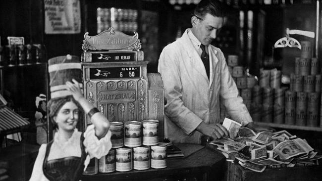 As a result of inflation in Weimar Germany, a grocer's cash register, which was formerly rarely full, had to be regularly emptied and its contents stored in a tea chest. Picture: Hulton-Deutsch Collection/Corbis via Getty Images