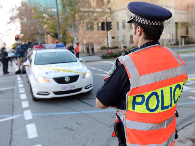 TENSE: Police block off King William Street at the corner of Gouger and Angus Sts. Picture: Tom Huntley