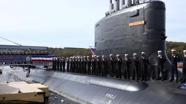 Crew members of the USS Illinois, the 13th ship of the Virginia class of submarines, stand topside during its commissioning in 2016. Picture: Reuters