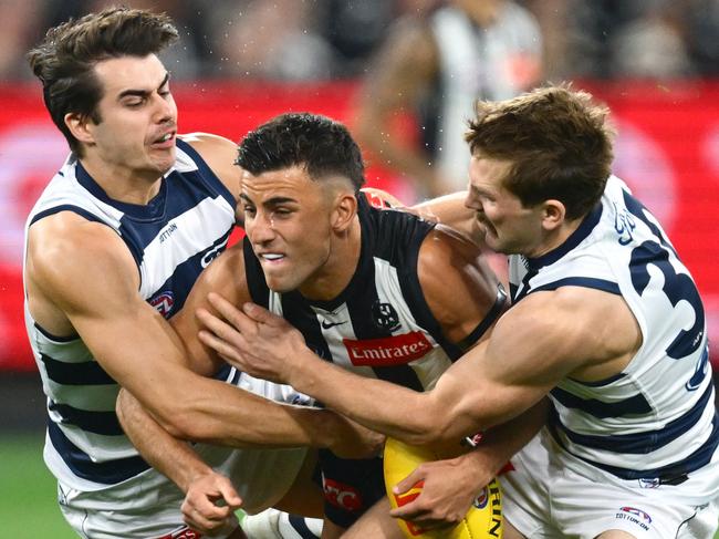 Nick Daicos is wrapped up by Oisin Mullin and Tom Atkins. Picture: Quinn Rooney/Getty Images