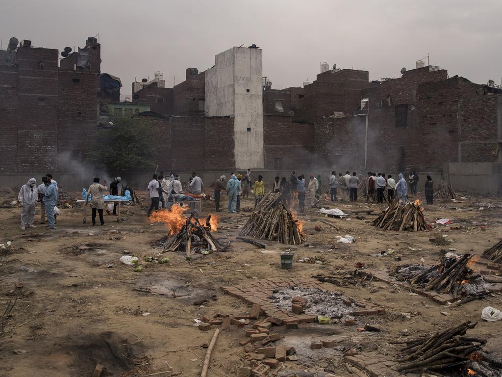 Multiple funeral pyres at a makeshift crematorium. Picture: Anindito Mukherjee/Getty Images