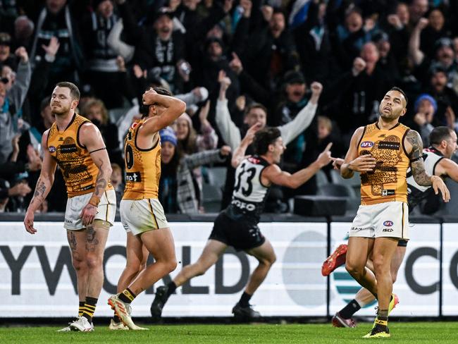 ADELAIDE, AUSTRALIA - MAY 19:  Darcy Byrne-Jones of the Power  celebrates  kicking a  goal to win the game as ,Blake Hardwick James Sicily and  Jarman Impey of the Hawks can't believe it  during the round 10 AFL match between Yartapuulti (the Port Adelaide Power) and Hawthorn Hawks at Adelaide Oval, on May 19, 2024, in Adelaide, Australia. (Photo by Mark Brake/Getty Images)