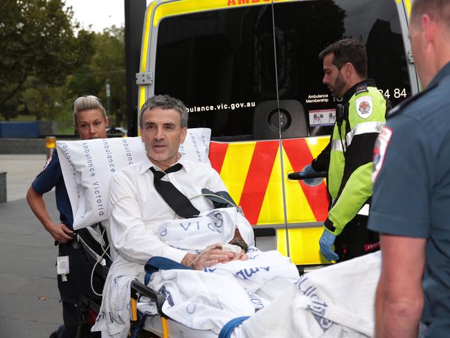 Dover responsible manager and owner Terry McMaster leaves the Federal Court with the aid of paramedics after collapsing while being questioned during the Banking Royal Commission in Melbourne, Thursday, April 26, 2018. The head of a financial advice firm has collapsed in the stand at the banking royal commission after begin accused of lying. (AAP Image/Stefan Postles) NO ARCHIVING