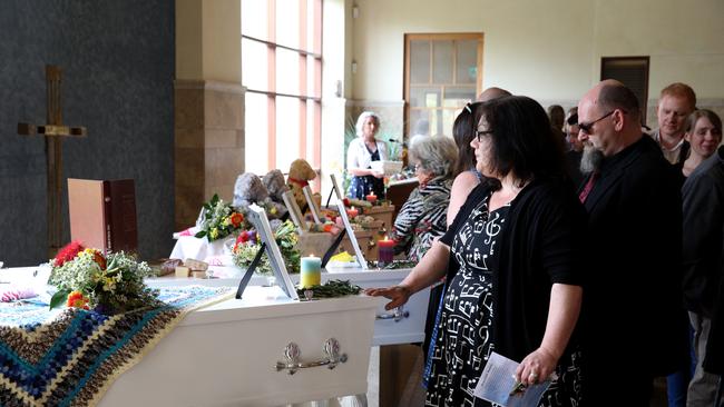 Mourners pay their respects during a funeral. Picture: Richard Wainwright/AAP