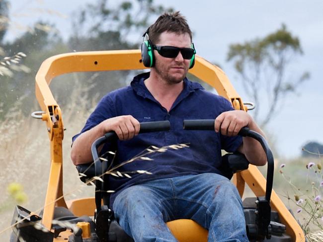 Mark and Melissa Beggs. Mark having to mow along roadside. White roadside markers still hidden by long grass on the  Princes Highway,Greenway Picture: Frank Monger