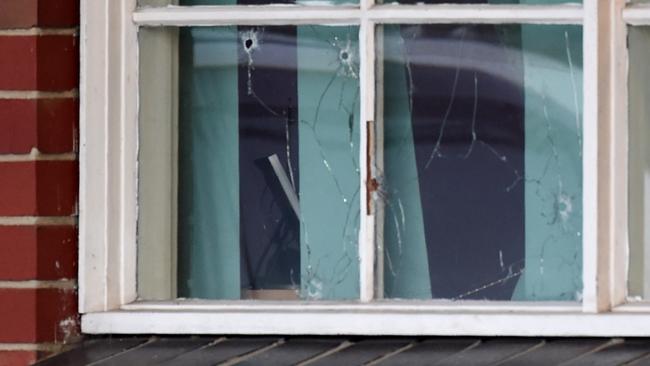 Bullet holes in the window of the Thomastown home where a man was killed. Picture: Nicole Garmston