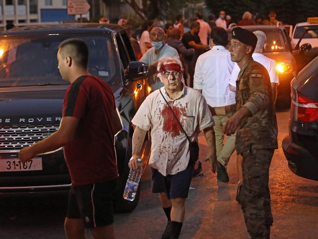 A wounded man is seen covered in blood as he walks outside a hospital after the explosion. Picture: Ibrahim Amro/AFP