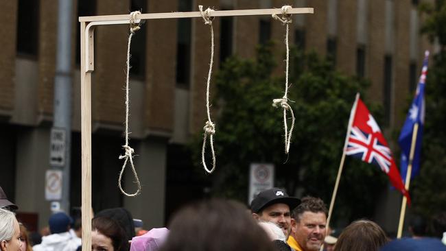 Disgraceful: Protesters carry fake gallows with nooses during a rally against the state government's proposed pandemic laws in Melbourne. Picture: NCA NewsWire / Daniel Pockett