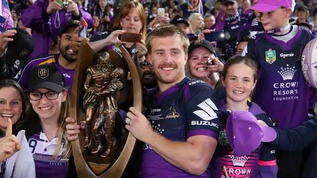 SYDNEY, AUSTRALIA — OCTOBER 01: Cameron Munster of the Storm holds aloft the Provan-Summons Trophy after winning the 2017 NRL Grand Final match between the Melbourne Storm and the North Queensland Cowboys at ANZ Stadium on October 1, 2017 in Sydney, Australia. (Photo by Cameron Spencer/Getty Images)