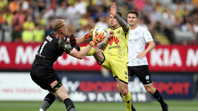 Tom Glover deals with the ball — and a boot — from Phoenix’s Gary Hooper. Picture: Getty Images