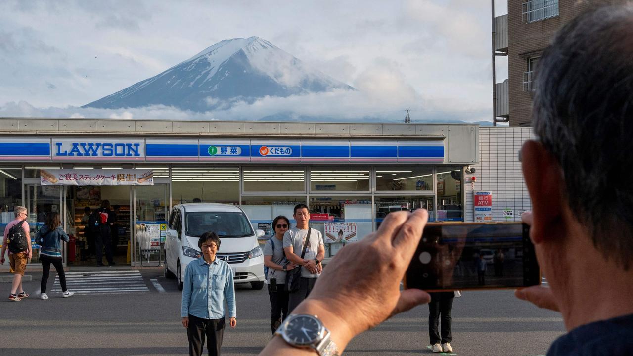 In May, a black barrier was erected to block this popular view of Mount Fuji because there were too many tourists. Picture: Kazuhiro Nogi / AFP