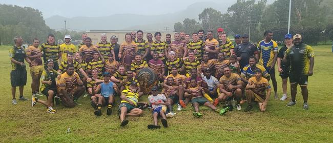 Players from the Palm Island Barracudas and Centrals Tigers after the Tigers' 26-4 victory on Palm. Players posed with the turtle shell gifted to Centrals after the first clash in 1983. Picture: Zac Nogar / Centrals Old Boys