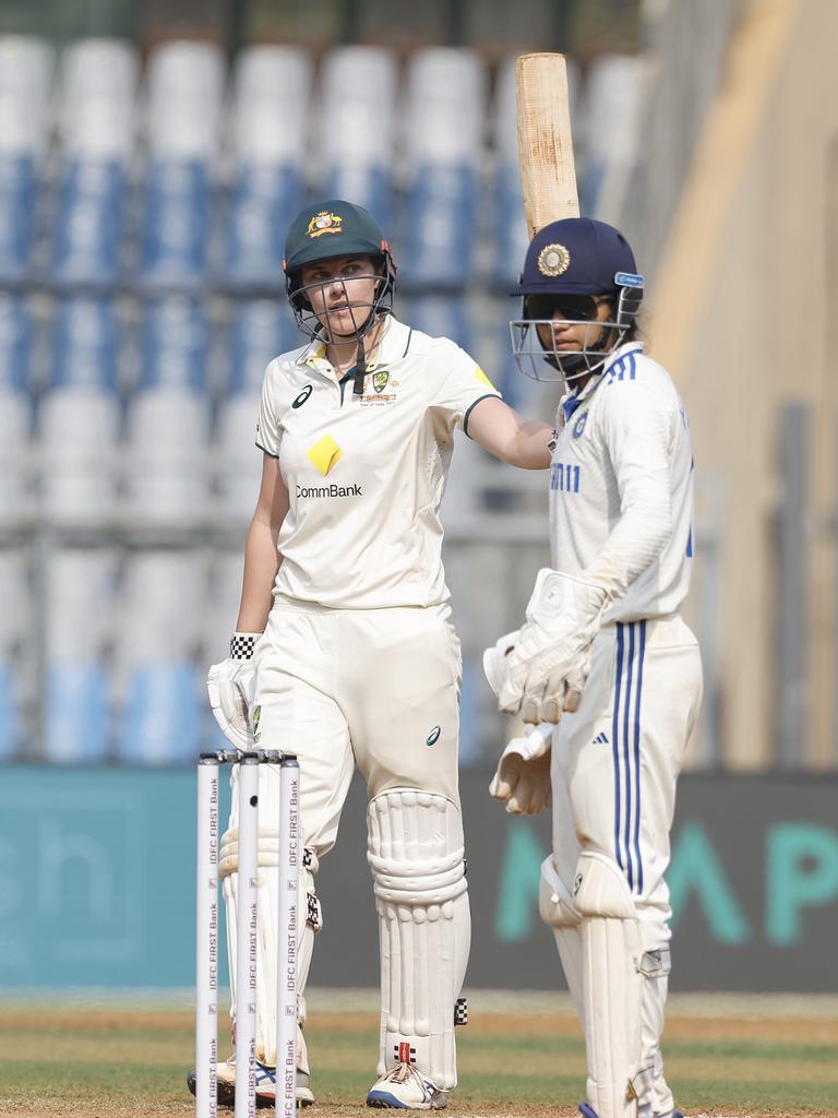 Tahlia McGrath raised her bat after a hard-fought half-century against India on Day 3 in Mumbai. Picture: Pankaj Nangia/Getty Images