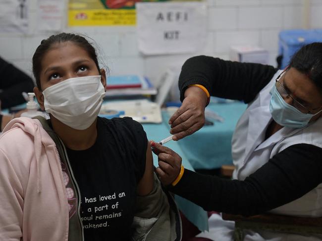 A health worker inoculates a youth with a Covid-19 vaccine during a vaccination drive for people in the 15-18 age group, in New Delhi. Picture: AFP