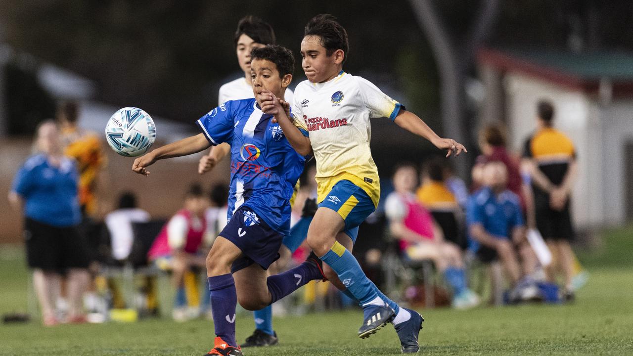 Amjad Eedo (left) of Rockville Rovers White against Alhassan Hussen of USQ FC in Football Queensland Darling Downs Community Juniors U13 Div 1 Maroon grand final at Clive Berghofer Stadium, Friday, August 30, 2024. Picture: Kevin Farmer