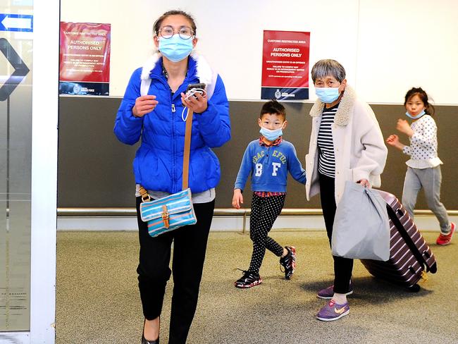 Air crew and passengers arriving from China wore masks at Brisbane Airport yesterday. Picture: John Gass/AAP