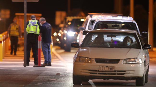 At the checkpoint near Yamba about a dozen cars wait to come through. Picture: Dean Martin