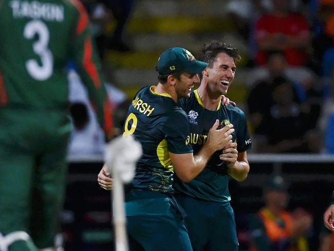 Pat Cummins of Australia celebrates with Mitchell Marsh after dismissing Bangladesh’s Taskin Ahmed for his hat trick. Picture: Gareth Copley/Getty Images