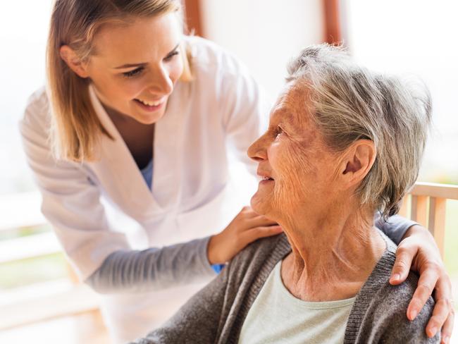 Health visitor and a senior woman during home visit. A nurse talking to an elderly woman. Aged care home care visit, senior generic