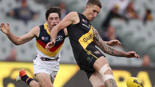 Jesse White gets his kick away from Adelaide’s Chayce Jones. Picture: SARAH REED.