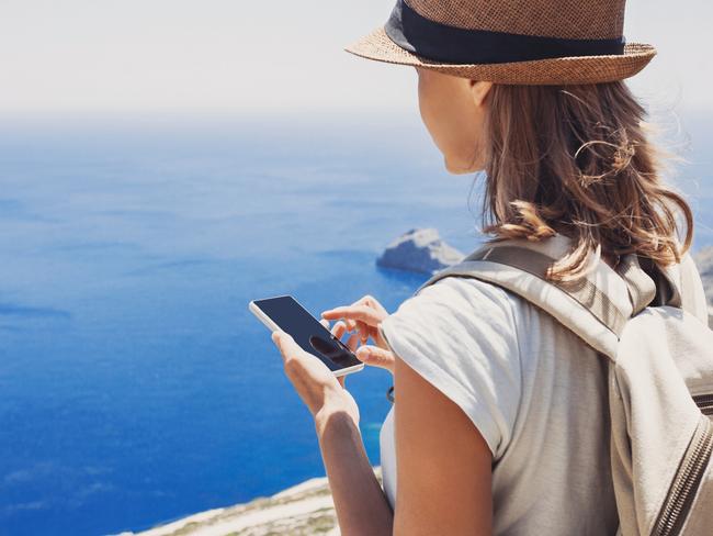 Young woman using smart phone on vacations, travel concept