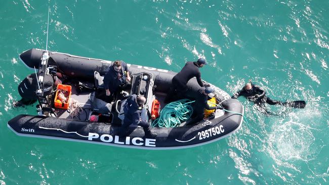 Police divers in action at the search scene. Picture: NIGEL HALLETT