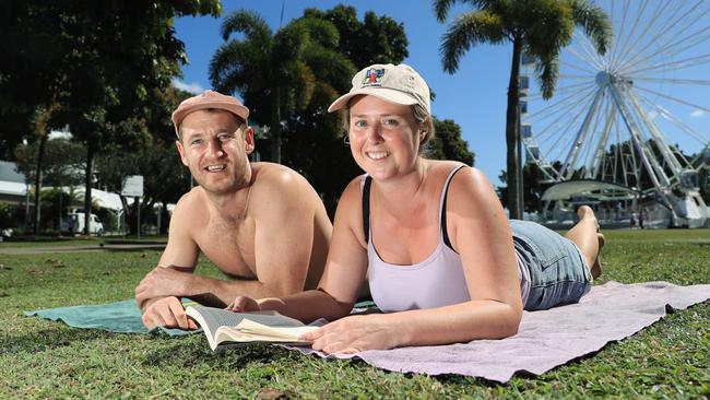 The weather in Cairns is forecast to heat up next week. Tyler Everson and Mia Lute from the Mornington Peninsula in Victoria enjoy soaking up the sun on the Esplanade. Picture: Brendan Radke