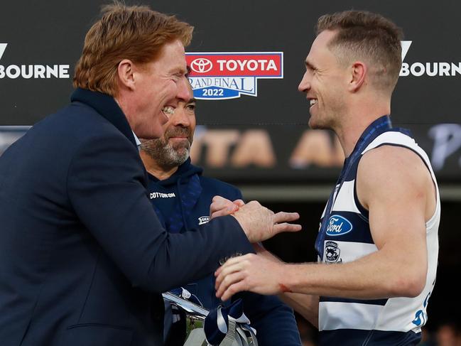 MELBOURNE, AUSTRALIA - SEPTEMBER 24: Cameron Ling presents the Cup to Chris Scott, Senior Coach of the Cats and Joel Selwood of the Cats during the 2022 Toyota AFL Grand Final match between the Geelong Cats and the Sydney Swans at the Melbourne Cricket Ground on September 24, 2022 in Melbourne, Australia. (Photo by Michael Willson/AFL Photos via Getty Images)