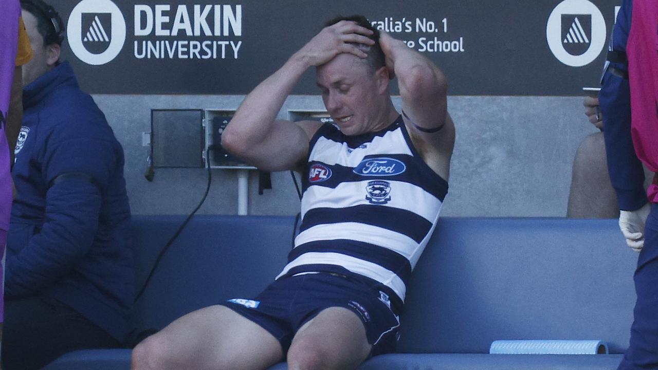 Mitch Duncan of the Cats left the ground and received medical attention after being tackled. Picture: Daniel Pockett