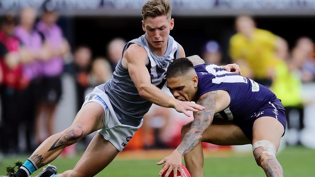 Port Adelaide’s Kane Farrell tackles Fremantle’s Michael Walters during the round 13 AFL match at Optus Stadium. Picture: Will Russell/AFL Photos/Getty Images.