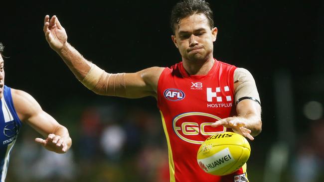 Action from the AFL match between the Gold Coast Suns and the North Melbourne Kangaroos, held at Cazalys Stadium, Cairns. Gold Coast's Jarrod Harbrow kicks down field. PICTURE: BRENDAN RADKE.