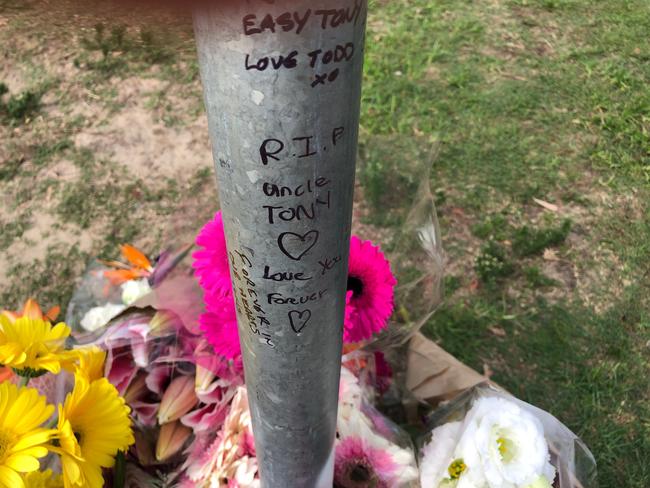 Flowers left at a roadside memorial to Freshwater hit and run victim Tony Plati at the corner of Oliver and Brighton streets.