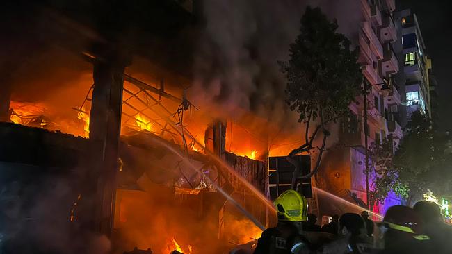 Lebanese firefighters douse the flames at the site of an Israeli strike that targeted a building in Beirut. Picture: AFP