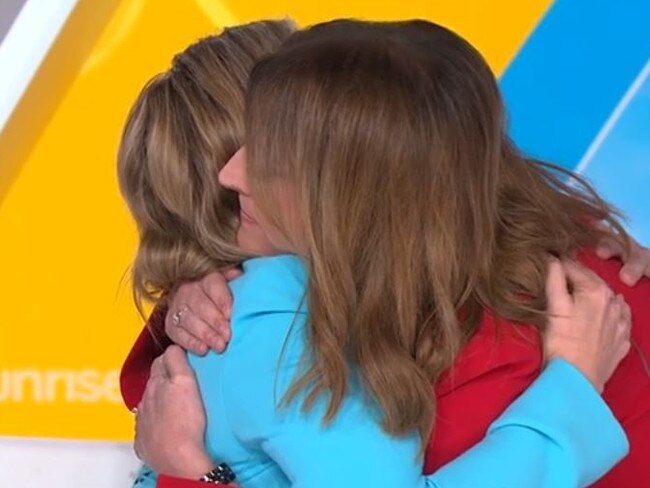 Nat Barr hugs Edwina Bartholomew after her colleague revealed her cancer disagnosis.