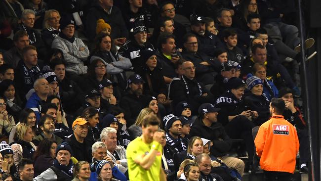 A security guards keeps a watch on the crowd at the Carlton v Western Bulldogs match. Picture: AAP