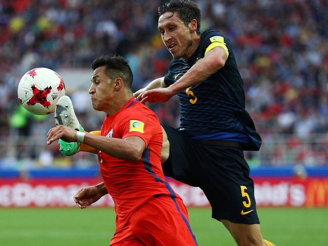 Mark Milligan keeps a close eye on the dangerous Alexis Sanchez.