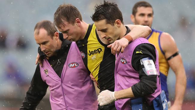 Dylan Grimes leaves the ground after falling awkwardly on his right ankle.