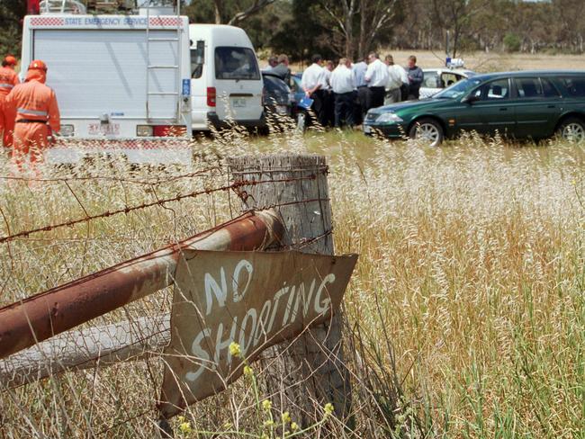 Detectives at the scene of the murder.