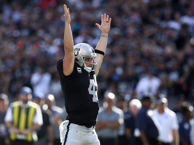 Derek Carr #4 of the Oakland Raiders celebrates after a one-yard rushing touchdown by Jamize Olawale #49 against the San Diego Chargers.