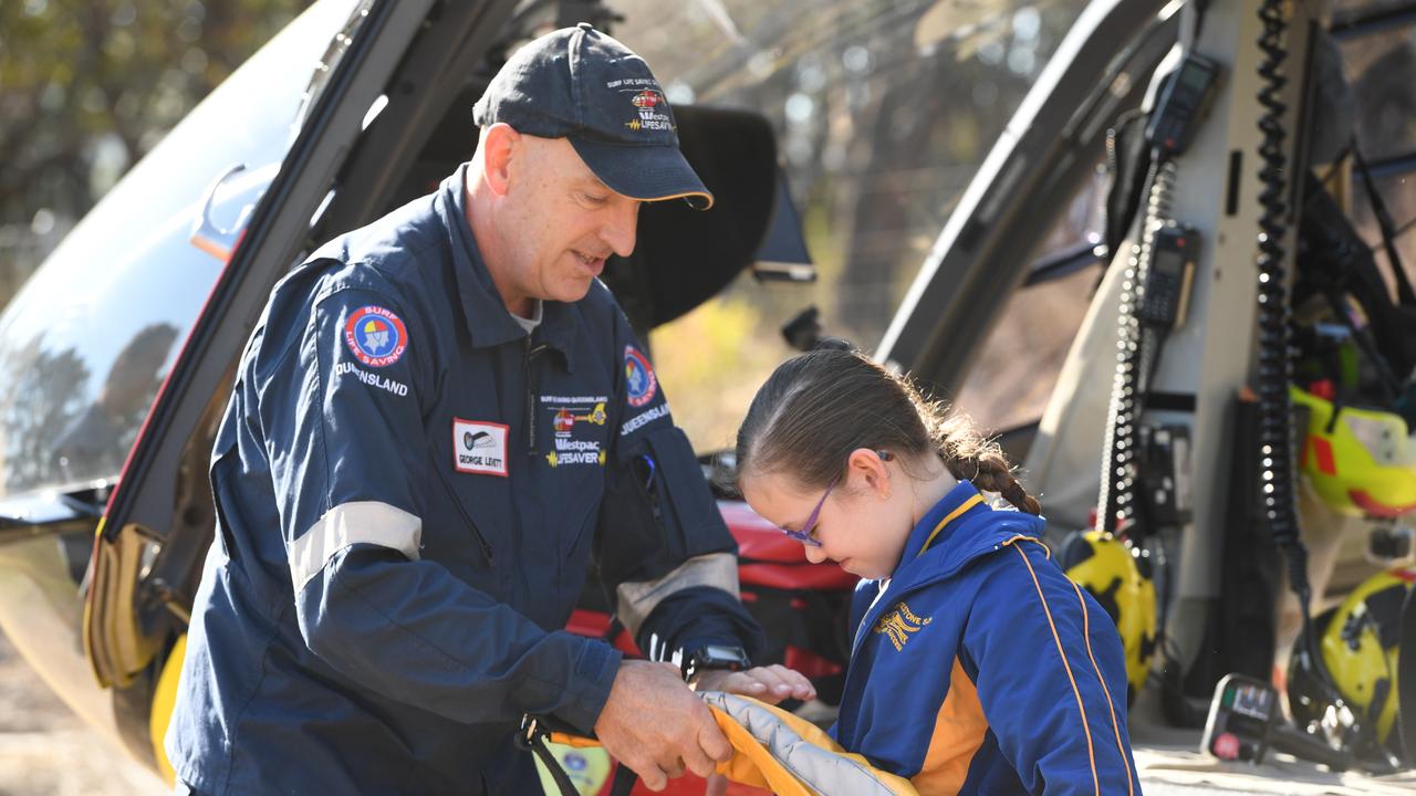 SLSQ Westpac helicopter demonstrate a rescue with Mount Whitestone State School student Eliza Sutton. PHOTO: ALI KUCHEL