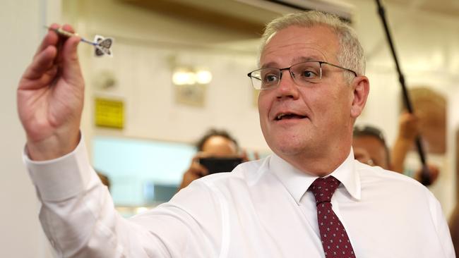 CAIRNS, AUSTRALIA - MAY 16: Prime Minister Scott Morrison plays darts during a visit to meet local community members at Railway Halls on May 16, 2022 in Cairns, Australia. The Australian federal election will be held on Saturday 21 May. (Photo by Asanka Ratnayake/Getty Images)