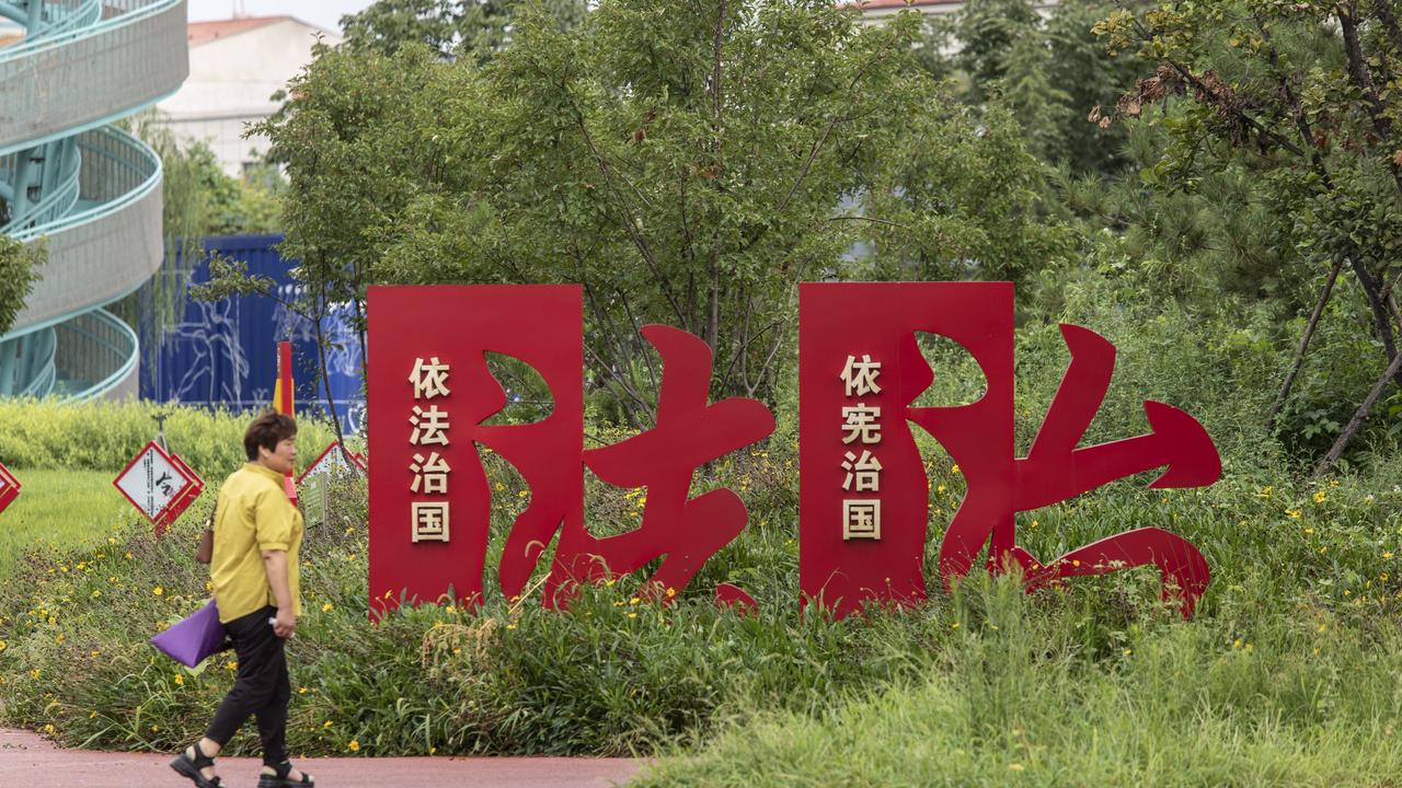 A pedestrian at the Constitution Park, adorned with slogans as well as quotations on Chinese President Xi Jinping's interpretation of the constitution, in Xiongan, China. Picture: Bloomberg