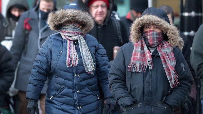 Commuters leave only their eyes exposed on their way to work in Chicago.