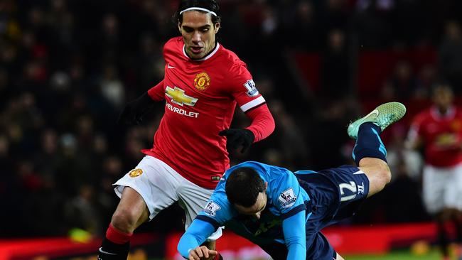 Stoke City's Northern Irish-born Irish defender Marc Wilson vies with Manchester United's Colombian striker Radamel Falcao (L) during the English Premier League football match between Manchester United and Stoke City at Old Trafford in Manchester, north west England, on December 2, 2014. AFP PHOTO / PAUL ELLIS RESTRICTED TO EDITORIAL USE. No use with unauthorized audio, video, data, fixture lists, club/league logos or “live” services. Online in-match use limited to 45 images, no video emulation. No use in betting, games or single club/league/player publications.