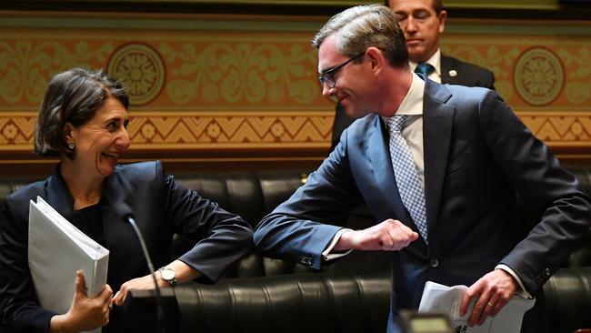 Gladys Berejiklian bumps elbows with NSW Treasurer Dominic Perrottet in NSW Parliament on November 17 — the day she was tested for COVID-19. Picture: AAP