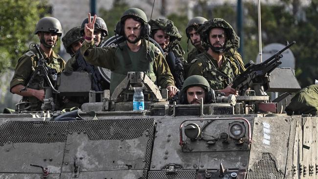 Israeli soldiers patrol in armoured personnel carriers at an undisclosed position in northern Israel near the borer with Lebanon. Picture: AFP