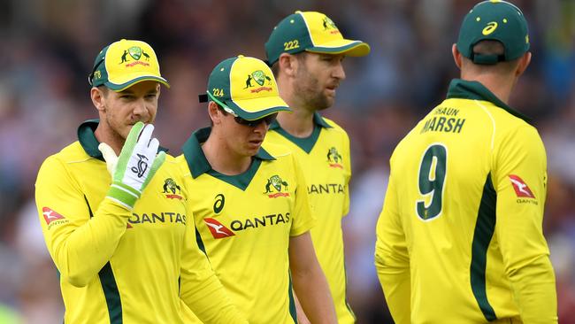 Australia’s captain Tim Paine, far left, leaves the field at the end of the England innings with shellshocked team-mates. Picture: Getty